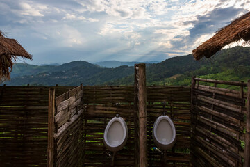 Natural mountain view passing from white urinal in men's toilet at Doi Chang, Chiang Rai, Northern Thailand.
