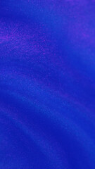 Abstract background. Glitter liquid flow. Fluid magic. Shimmering bright blue paint grain texture captivating stream motion in ink water art.