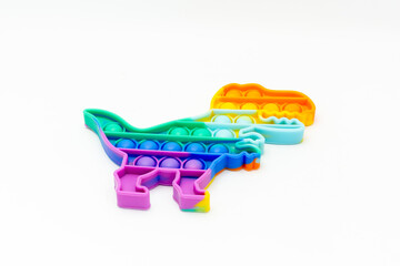 Rainbow dinosaur shaped pot it toys isolated on white background. Sensory Silicone Toys for Autism,...