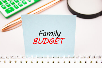 FAMILY BUDGET text, acronym on table with calculator. Family budget, management, planning, financial concept.