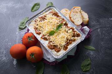 Bolognese and pesto frozen Lasagna on metal Tray for food delivery
