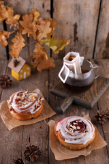 Pastries and coffee in a drip bag on a wooden table.