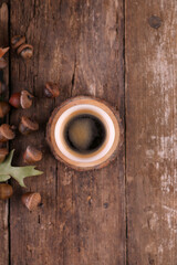 Small portion of coffee and acorns on a wooden table