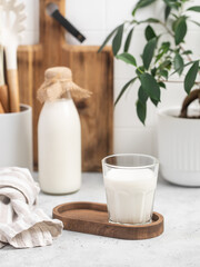 Milk in a glass, bottle of milk, light stylish kitchen