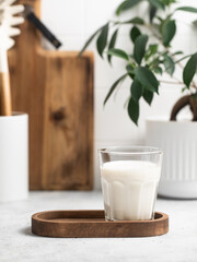 Milk in a glass, bottle of milk, light stylish kitchen