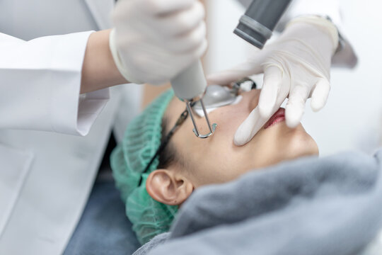 Woman receiving pico laser facial treatment in beauty Clinic.
