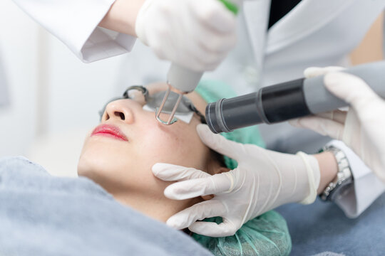 Woman receiving pico laser facial treatment in beauty Clinic.