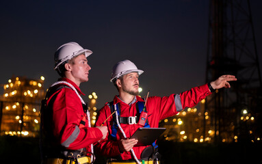 Engineer survey team wear uniform and helmet stand workplace checking blueprint project and radio...