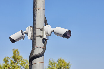 Security cameras are installed in the park on an electricity pole