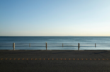 Beach road at twilight with lonely mood. Quiet beach in the evening at Kamakura in Japan. 