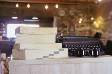Stack of books on wooden desk in the library room background. Education and knowledge concept. Pile...
