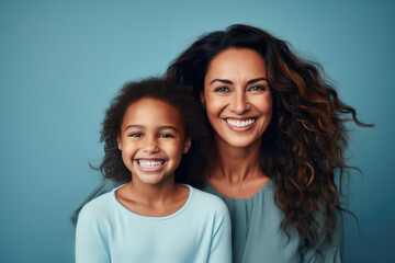 Heartwarming image of woman and little girl smiling together, posing for picture. Perfect for capturing joyful moments and creating lasting memories.