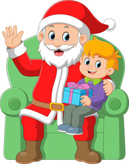 Santa claus sitting in chair with a little cute boy