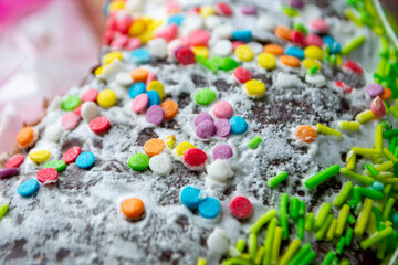 Traditional easter holiday table served with homemade easter cake . A cake with sprinkles on it is decorated with colorful sprinkles. High quality photo