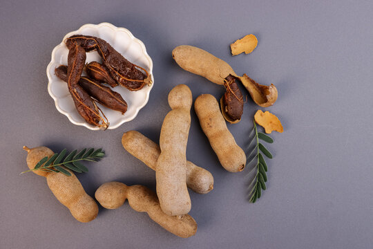 Buah Asam or Tamarind (Tamarindus) Fruit With Green Leaves.