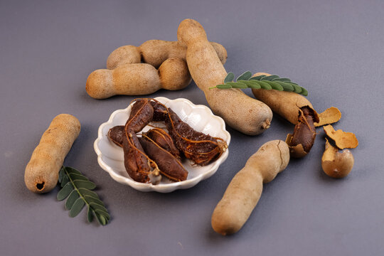 Buah Asam or Tamarind (Tamarindus) Fruit With Green Leaves.