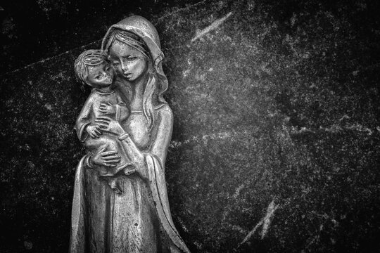 Virgin Mary with the baby Jesus Christ. Religion, faith, eternal life, God, the soul concept. Copy space. Black and white image.