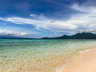 Fototapeta na wymiar Beautiful sandy beach and ocean waves in Camiguin Island, Philippines.