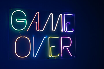 game over neon sign color on a dark wall background