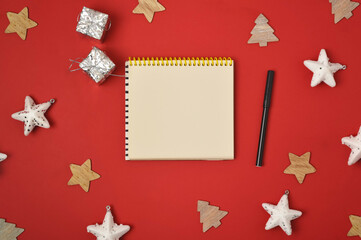 Christmas holiday concept. Blank sheet of paper with pen on red background with Christmas decorations. Santa s List Day