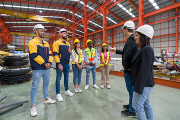 Warehouse safety meeting, people with hardhat. Industrial teamwork.