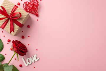 Celebrate St. Valentine's Day with a delightful arrangement: craft paper gift box, rattan heart, red rose, "love" declaration, sprinkles, and a pastel pink setting for your message or promo