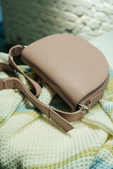 The choice of clothes, the girl's hand in choosing a dress, an outfit on a hanger in the wardrobe in the room, a closet at home. Wardrobe in the house. Clothes for women. Bags. Clothing store.