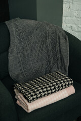 The choice of clothes, the girl's hand in choosing a dress, an outfit on a hanger in the wardrobe in the room, a closet at home. Wardrobe in the house. Clothes for women. Bags. Clothing store.