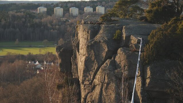 Empty Slackline hanging over Cliff in Gothenburg, Sweden at Sunset, Medium shot