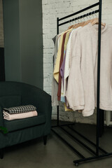 The choice of clothes, the girl's hand in choosing a dress, an outfit on a hanger in the wardrobe in the room, a closet at home. Wardrobe in the house. Clothes for women. Bags. Clothing store.