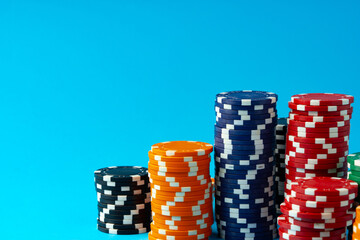 Stacks of poker chips on blue background