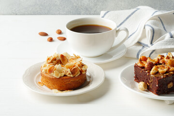 Almond tart and brownie on white background