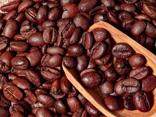 Antique vintage retro bronze coffee mill on black wooden board with roasted coffee beans