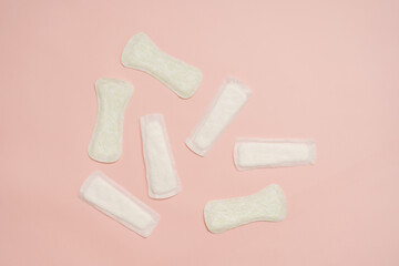 Different feminine sanitary napkins (sanitary pads) on pink background. Menstruation