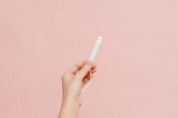 Medical feminine tampon in hand. Cotton swab. Menstruation