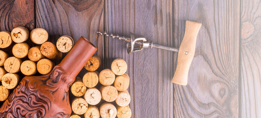 Fototapeta na wymiar Bottle of wine with corks on wooden table background. on soft sunlight