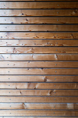 Naklejka premium The wall is covered with wooden boards in a horizontal arrangement