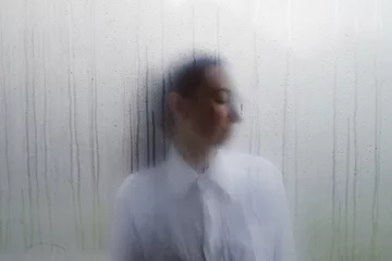 Foto op Aluminium Woman behind wet foggy window. Loneliness concept © 4Max
