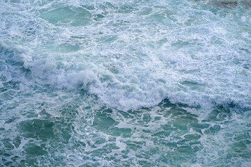 Fototapeta premium Element. Storm waves on the sea.Texture of the stormy sea. Beautiful texture of big power dark waves with white foam.