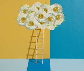 Wooden ladder leading to a cloud made of white flowers on a turquoise, yellow and pastel blue...