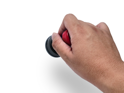 Hand holding red handled round rubber stamp, top view isolated on white