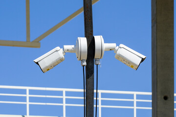 Pole with two outdoor security CCTV cameras or surveillance system in an unfinished construction...