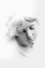 Fragment of ancient statue: face of white beautiful angel. Vertical image.