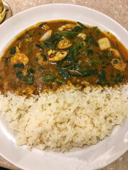Spinach Seafood Curry Rice in a white bowl.
