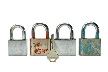 Fototapeta premium 4 padlocks and 1 key isolated on a white background.