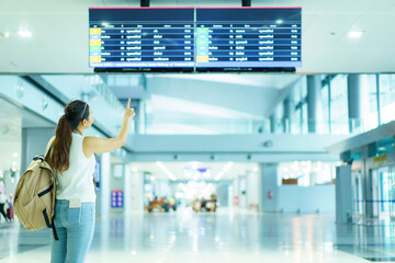 Woman checking a flight schedule.
