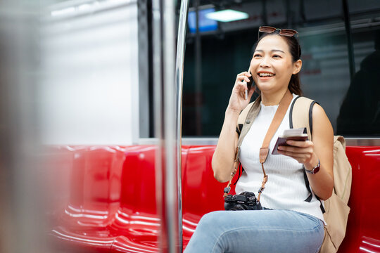Woman passenger using mobile phone searching for a transportation information.