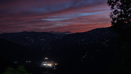 kalimpong valley during night time. Mighty kangchenjunga in the the background. The houses & towns illuminated with nightfall.