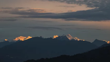 Poster Kangchendzönga Mount kangchenjunga peak of Himalayan mountains during sunrise. Snow clad golden white peaks under cloud cover as seen fro kalimpong india.