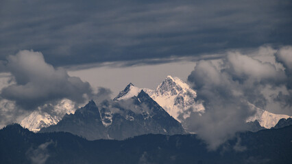 Mount kangchenjunga peak of Himalayan mountains at dawn. Snow clad white peaks under cloud cover as seen fro kalimpong india.